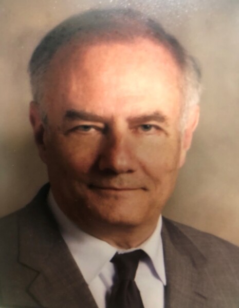 A man in a suit and tie with a slight smile, set against a neutral background, represents the dedication found at the Louisiana Public Defender's Office.